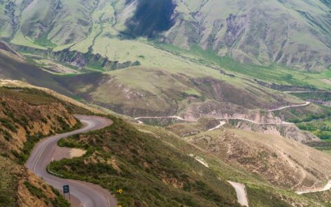 Aerial view of winding roads and lush mountains in Salta, Argentina.