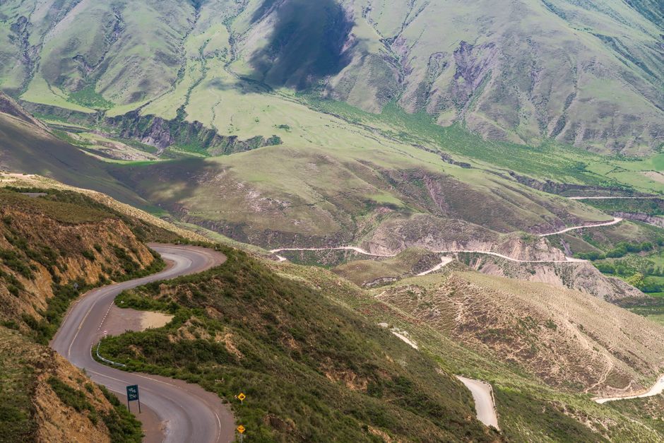 Aerial view of winding roads and lush mountains in Salta, Argentina.