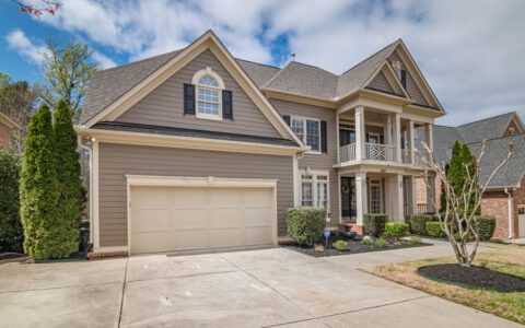 A beautiful suburban home with a spacious front garage and manicured lawns.